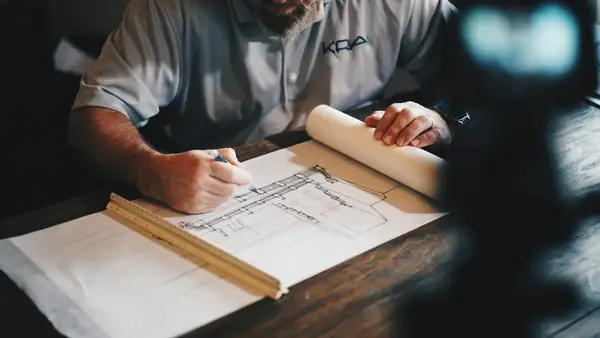 Project manager marking up construction drawings